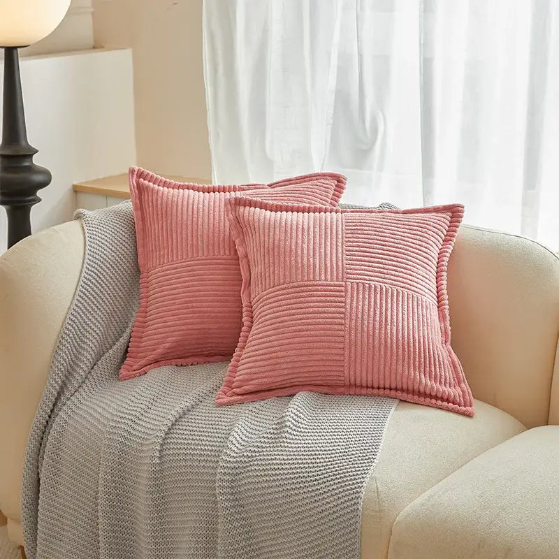 Two soft pink corduroy boho striped pillow covers with subtle quilted pattern on beige sofa for decorbites boho striped decor