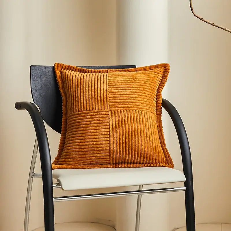 Warm orange corduroy throw pillow with quilted patchwork design complementing decorbites boho striped pillow covers