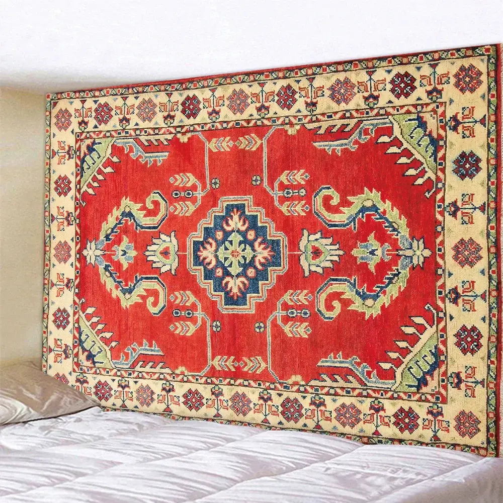 Vibrant red and gold decorbites boho tapestry set with intricate geometric patterns hanging above a bedroom bed