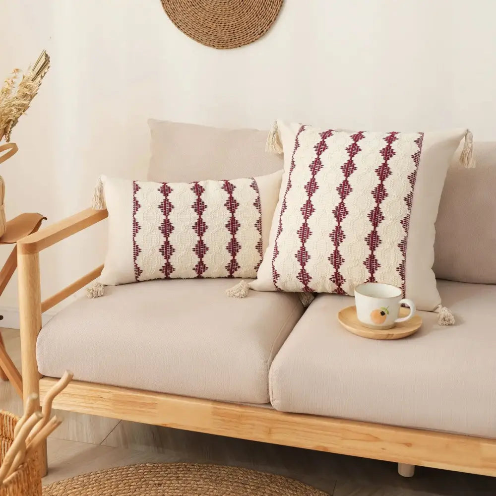 Cream-colored tassel cushion cover with maroon geometric embroidery for beige and gray boho living room decor