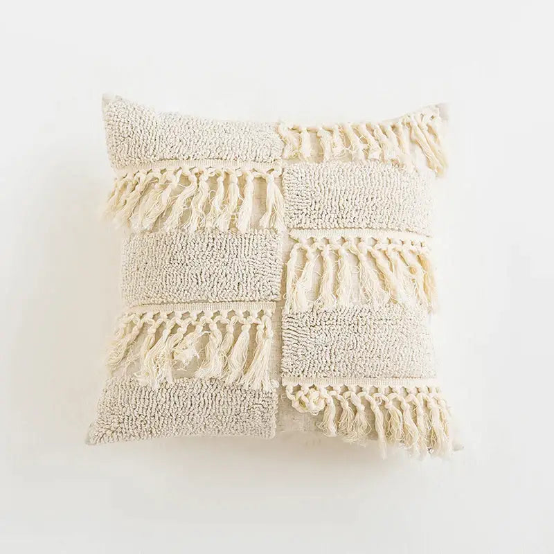 Cream-colored textured cushion cover with patchwork diamond design and fringe decorbites boho tassel cushion