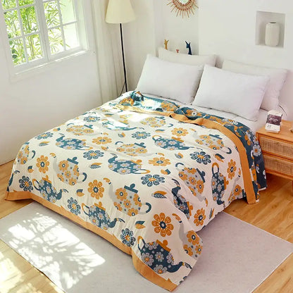 Cozy cream-colored decorbites cotton boho throw blanket with teal and mustard teapots and matching solid mustard border