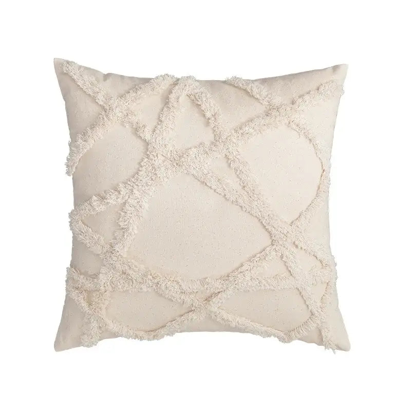 Cream-colored cushion cover with textured frayed geometric pattern in decorbites boho tufted embroidered style