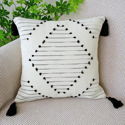 White throw pillow with black embroidered lines and tassels boho tufted fringed black living room decorbites decor