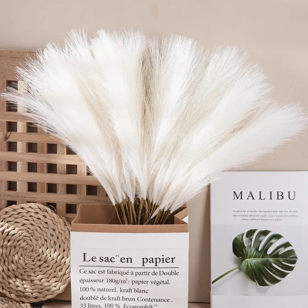 A bouquet of fluffy white pampas grass arranged in a brown paper box for boho living room decor by decorbites fluffy pampas