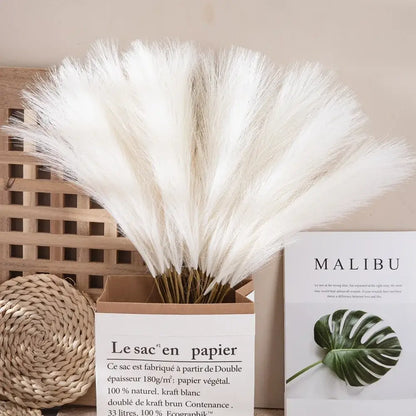A bouquet of fluffy white pampas grass arranged in a brown paper box for boho living room decor by decorbites fluffy pampas