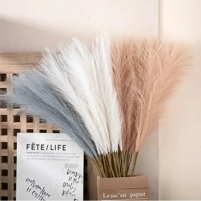 A bouquet of decorbites fluffy pampas grass in soft blue white and blush pink hues in a rustic brown box for living room decor