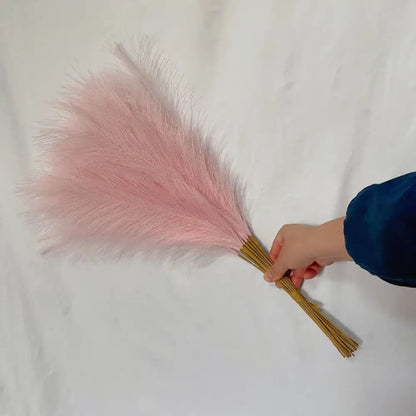 Soft pink feather duster with natural wooden handle complementing boho white beige fluffy pampas grass decorbites fluffy pampas