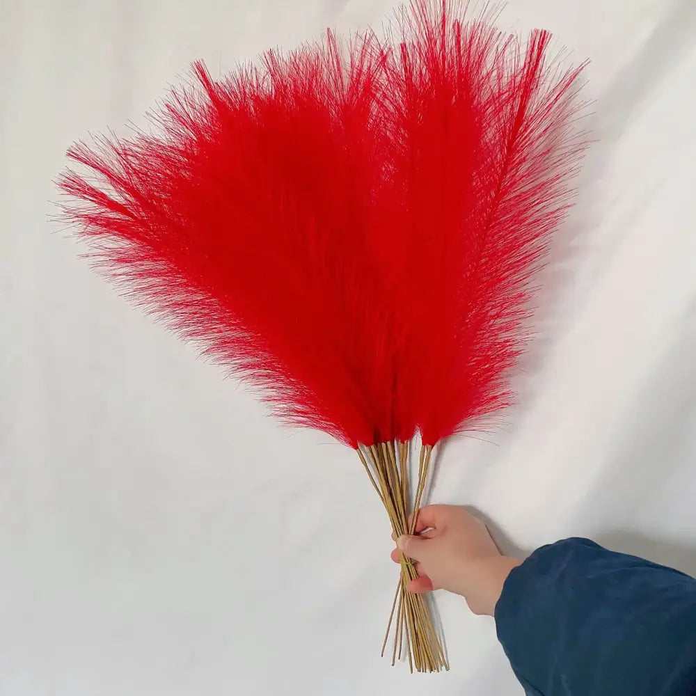A vibrant red feather bouquet with fluffy plumes and slender golden stems for boho pampas grass living room decorbites fluffy pampas