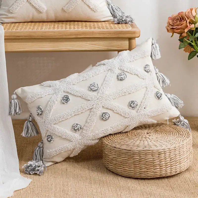 Cream-colored boho loop pillowcase with textured white tassels and gray embroidered floral accents cushion cover