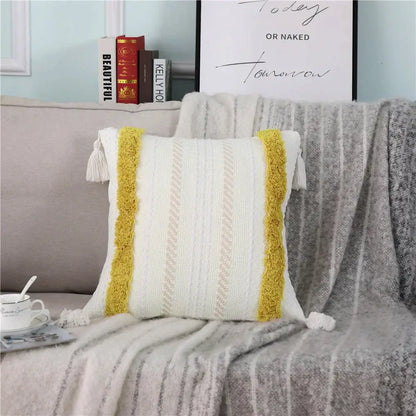 White knit pillow case with mustard yellow tassel trim and textured vertical stripes decorbites boho woven tassel design