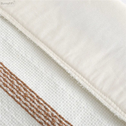 White textured fabric pillow case with brown and white woven stripe border boho woven tassel decorbites design