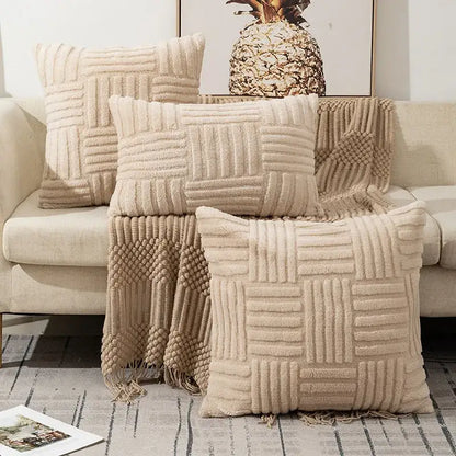 Beige plush throw pillow covers with woven geometric patterns and fringed edges for boho living room decor