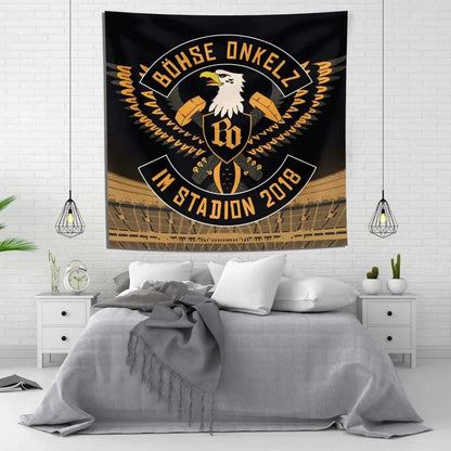 Black and gold tapestry flag with bohse onkelzs stylized eagle emblem and german rock text in a stadium setting
