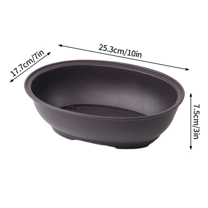 Dark gray oval ceramic plant pot with smooth matte finish and subtle footed base for para plantas or pot flowerpots