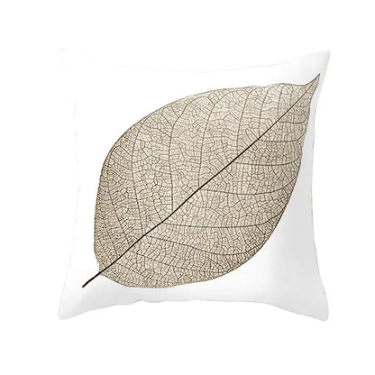 White plush throw pillow featuring a detailed beige autumn maple leaves silhouette with intricate vein patterns for living room decor