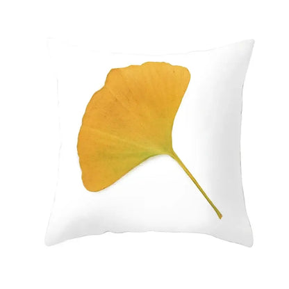 White throw pillow with golden-yellow ginkgo leaf print featuring autumn maple leaves for living room decor