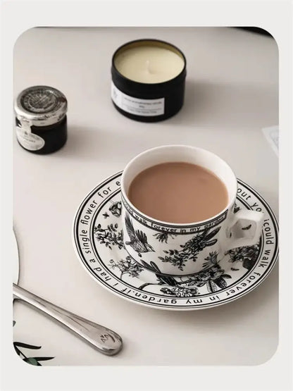 White ceramic teacup with black bird ceramic pattern filled with tea from decorbites black bird coffee set