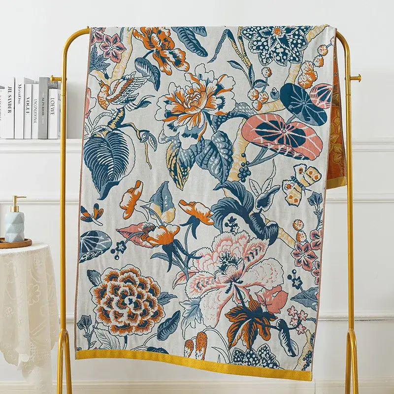 A vibrant botanical blue and orange cotton gauze bath towel with floral pattern for decorbites cotton gauze bath use