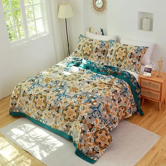 A decorbites cotton leisure blanket with vibrant teal gold floral mandala designs on an off-white cotton leisure bedspread