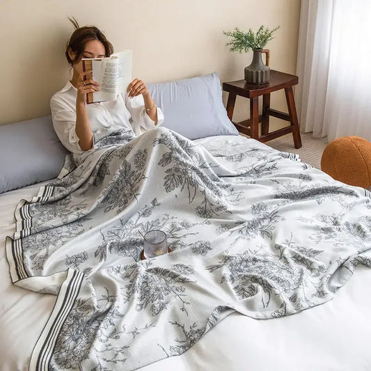 A soft white summer quilt with gray botanical print and striped border made from decorbites bamboo four layer fabric
