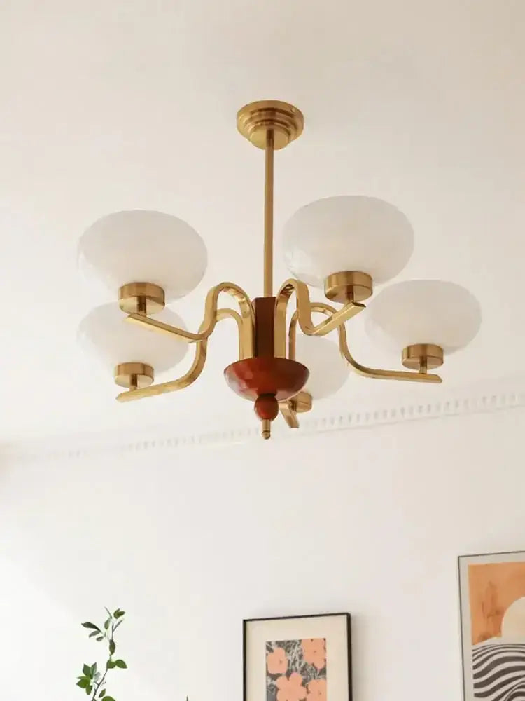 Vintage-style brass and cream glass pendant chandelier with five frosted shades and wooden accent for dining room decorbites cream glass