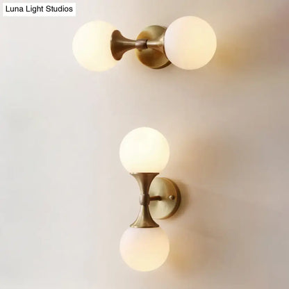 Decorbites™ ivory glass ball wall lamp with two frosted glass globe shades and brass-finished two-head wall lamp