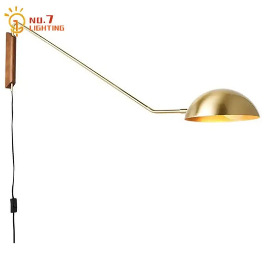 Brass and wood adjustable metal wood wall lamp with curved arm and wooden backplate for bedroom reading light