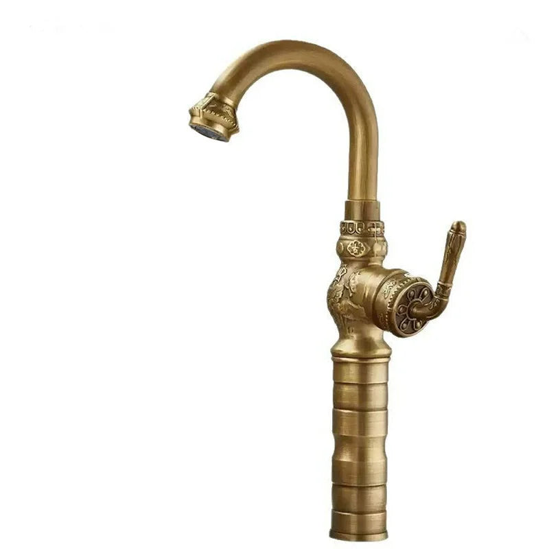 Brass antique bathroom sink faucet with antique brass finish ornate detailing and a curved spout