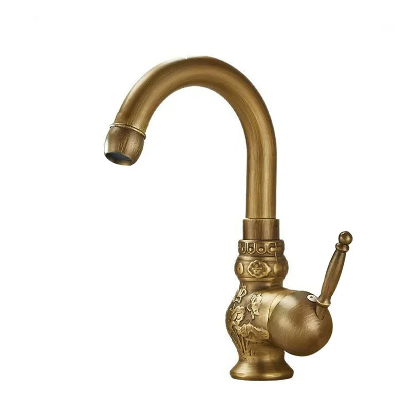 Brass antique bathroom sink faucet with an antique brass finish, ornate floral and geometric embossing, curved spout, and elegant handle