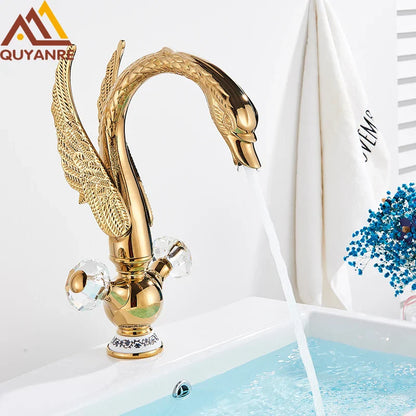 Brass basin faucet deck mounted in antique brass with golden swan shape and crystal knob detailing