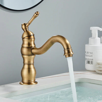 Antique brass-finished single-handle bathroom basin mixer faucet with curved spout and decorative ridged body