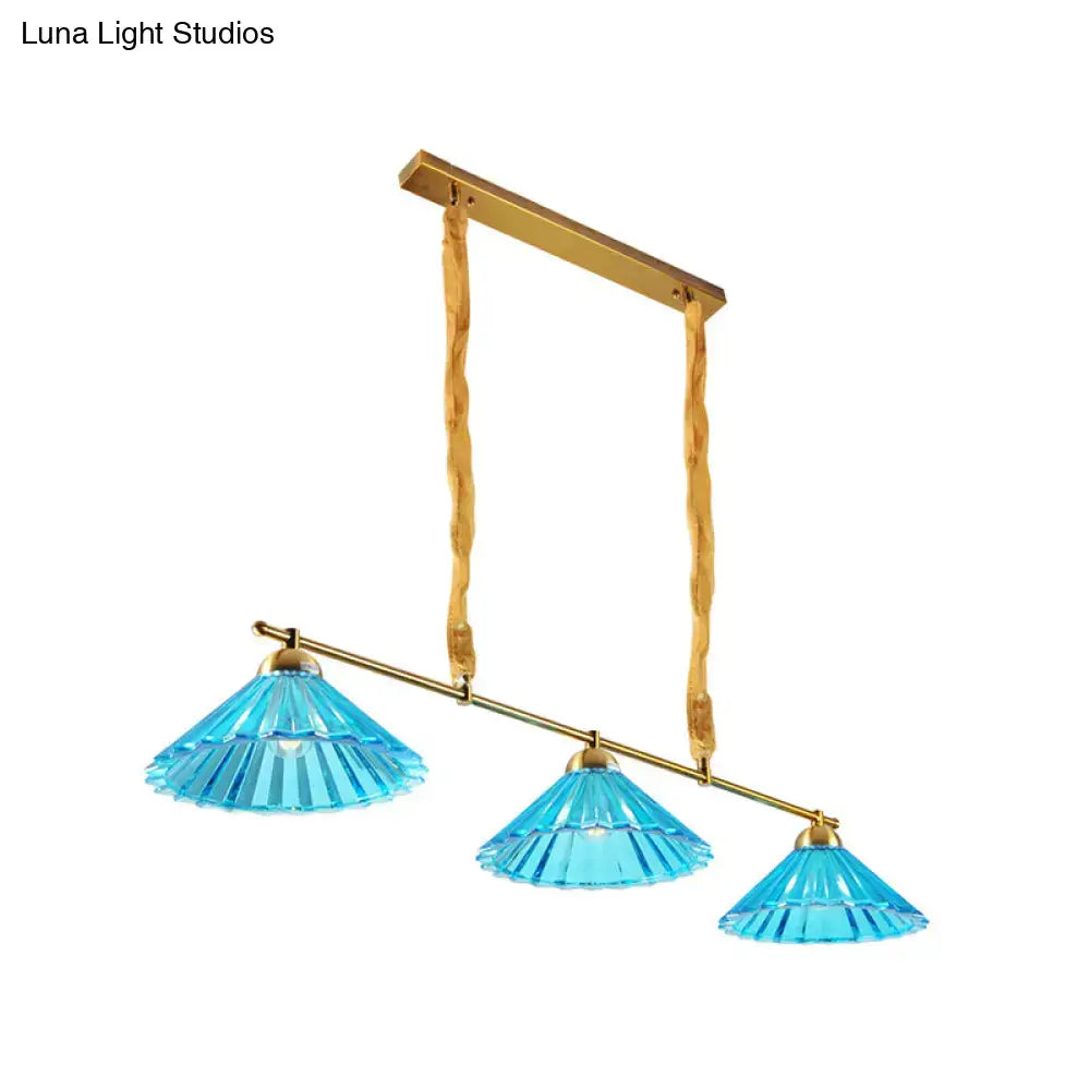 Blue ribbed glass cone pendant light with brass accents and twisted rope suspension for traditional dining rooms