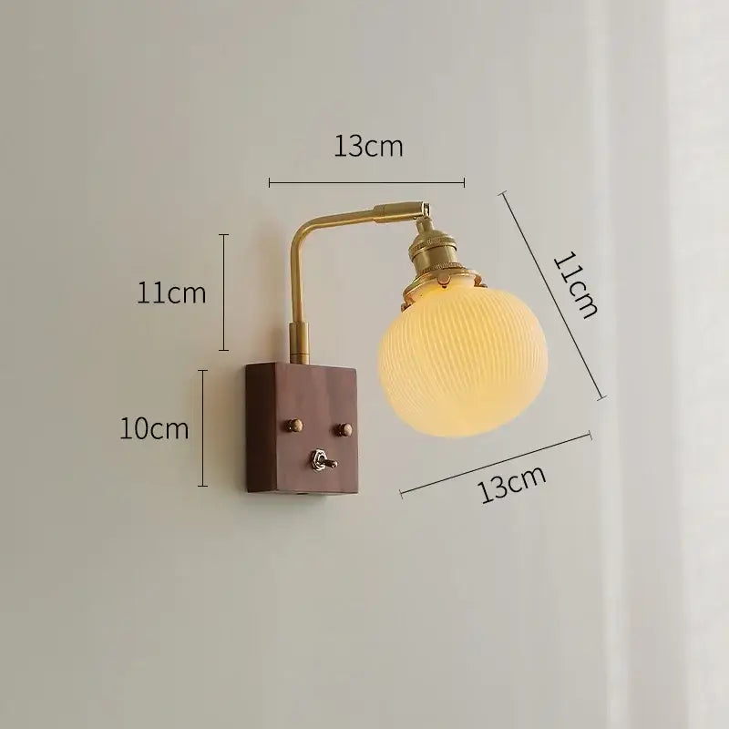 Brass ceramic ball led wall light with yellow globe featuring a brass-finished arm and ribbed glass for living room use