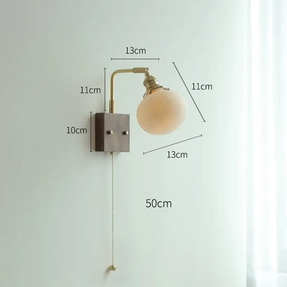 Vintage-style brass led wall light with frosted yellow globe and adjustable arm for living room lighting