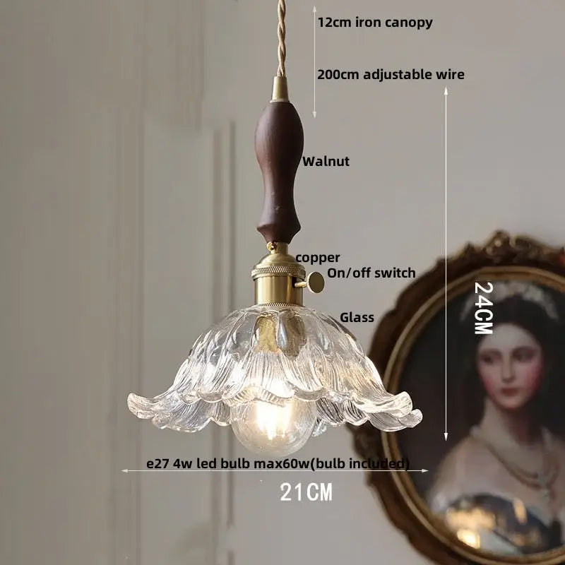 A delicate clear glass led pendant light with fluted petal design and dark walnut handle for dining room decorbites