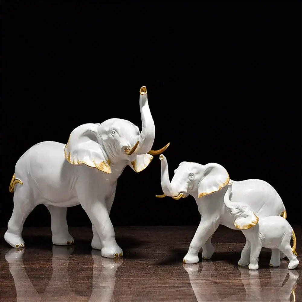 White ceramic elephant figurine set with gold accents on ears trunks and feet decorbites elephant art for living room decor