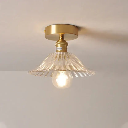Gold-finished ceiling lamp with clear fluted glass shade pendant and exposed bulb for kitchen lighting