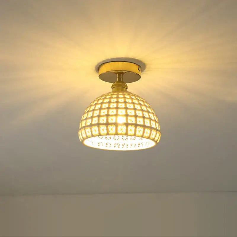 A warm-toned glass shade pendant ceiling lamp with brass finish and intricate mosaic tiles for kitchen lights