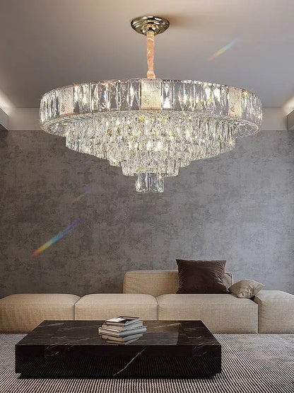 Brass multi tiered decorbites crystal ceiling chandelier with polished brass mount and cascading faceted glass elements