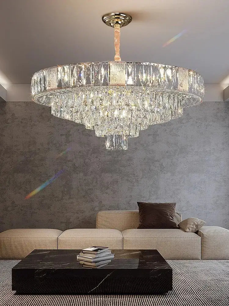 Brass multi tiered decorbites crystal ceiling chandelier with polished brass mount and cascading faceted glass elements