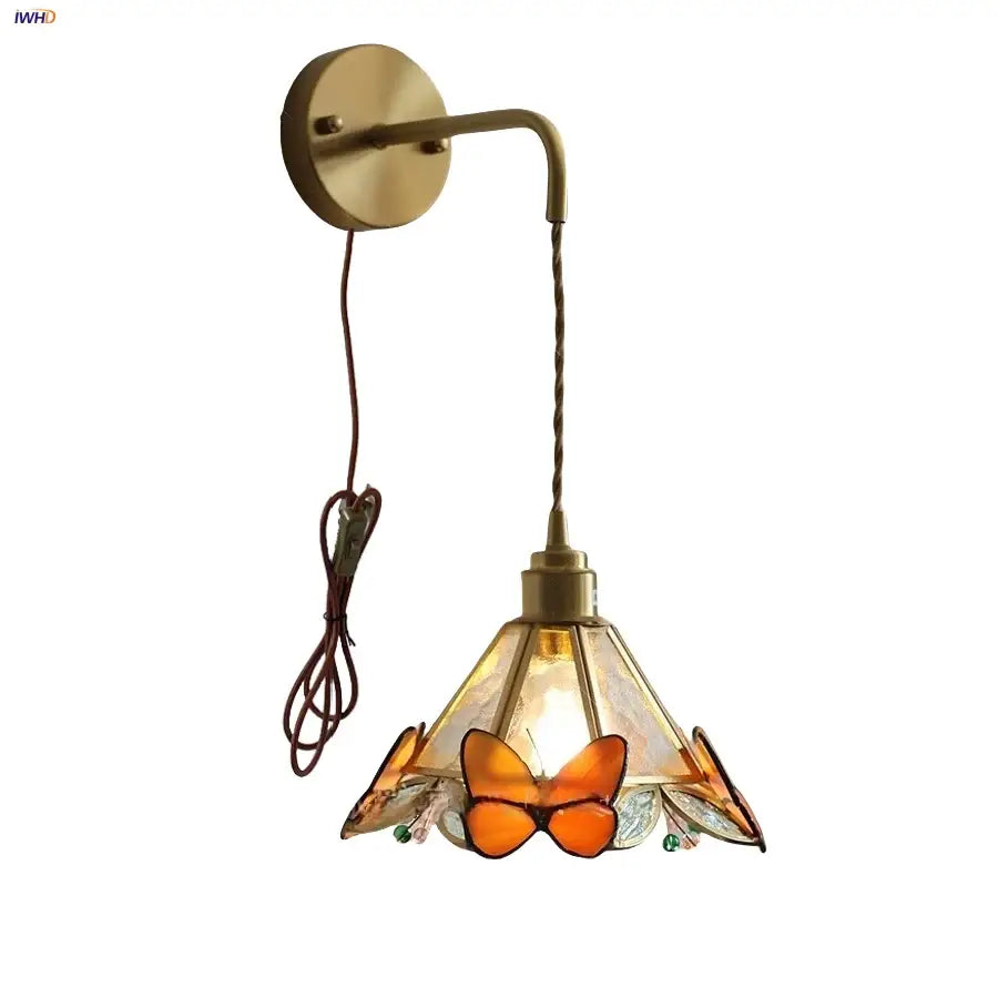 Brass orange butterfly stained glass wall light fixture with amber accents for bedroom sconce lighting