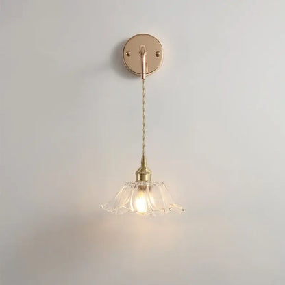 A delicate brass petal glass decorbites adjustable led wall light with a fluted shade and twisted cord