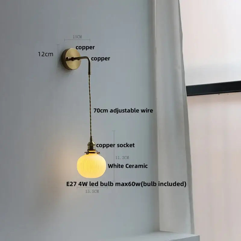 A warm glowing white ceramic wall light with copper finish and adjustable wire decorbites adjustable led bedroom light