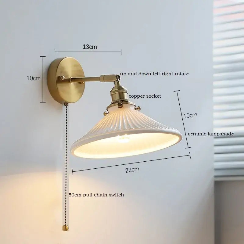 Antique brass wall sconce with ribbed white decorbites ceramic lampshade and copper socket on iron arm for bedroom light
