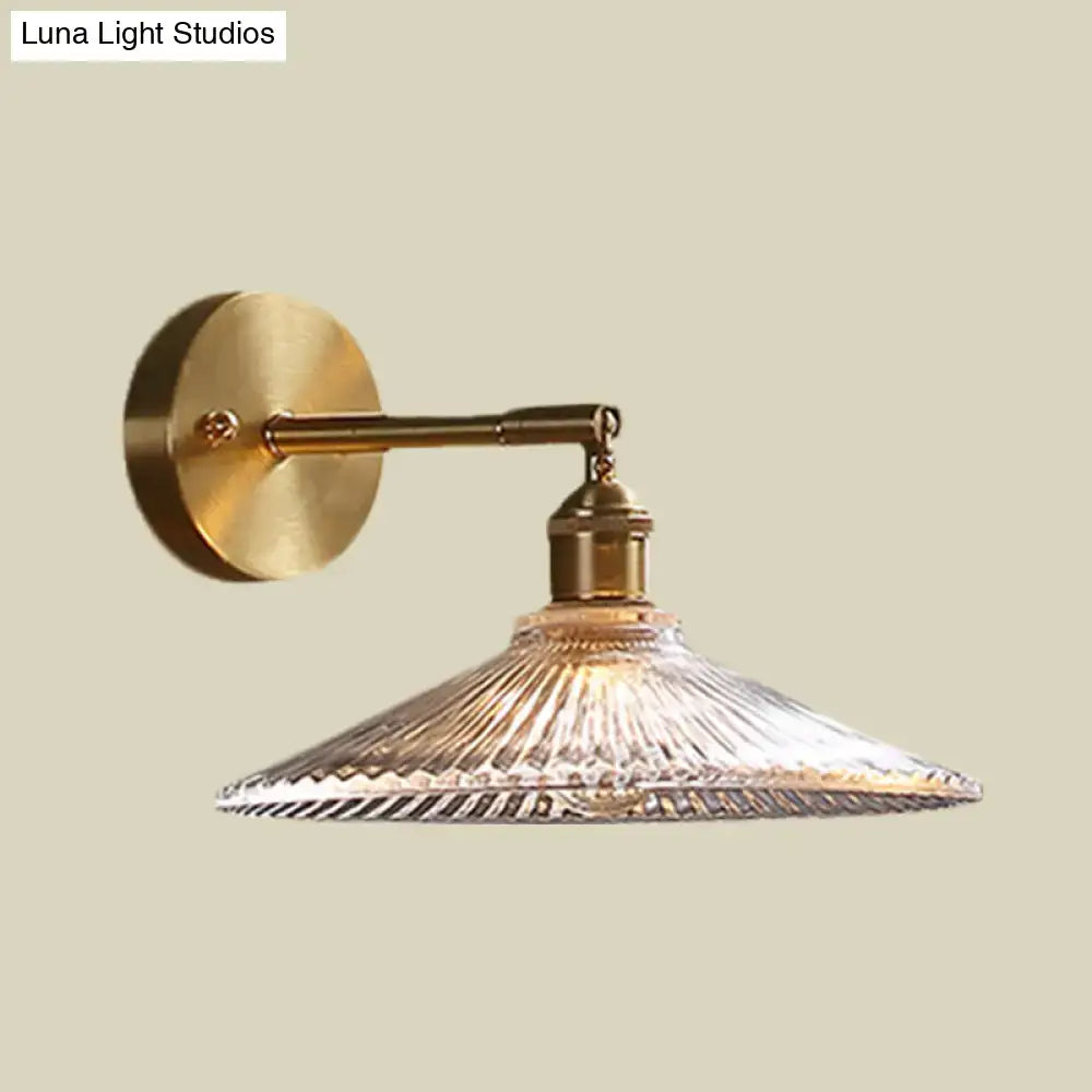 Brass scalloped glass shade bedside sconce light with a clear ribbed glass shade and brass-finished fixture