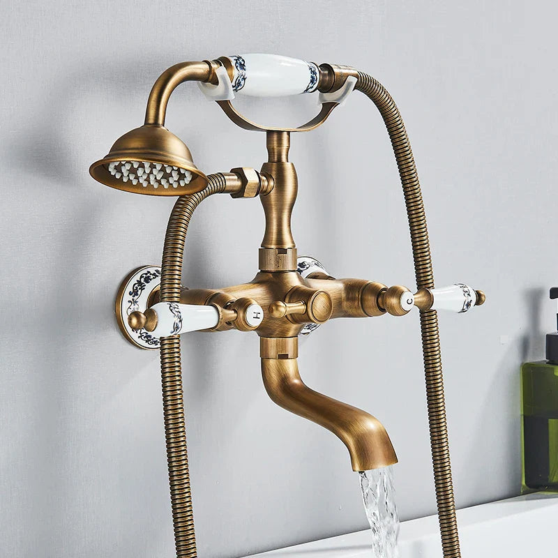 Antique brass shower faucet wall mount with white ceramic handles, black floral patterns, fixed showerhead, and cold water control