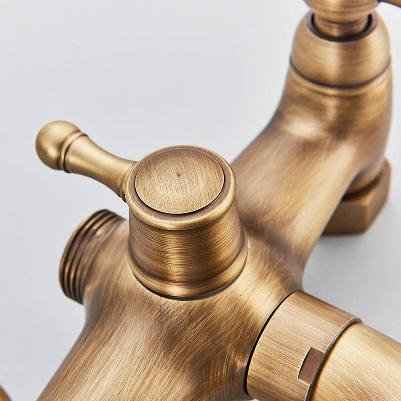 Antique brass-finished brass shower faucet wall mount with brushed metal texture and ornate design for cold water use