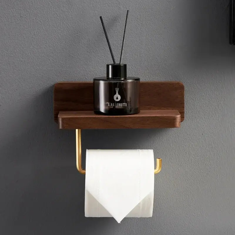 Brass and wood toilet roll holder stand with gold-toned wall mount and shelf holding an alba lonutti diffuser
