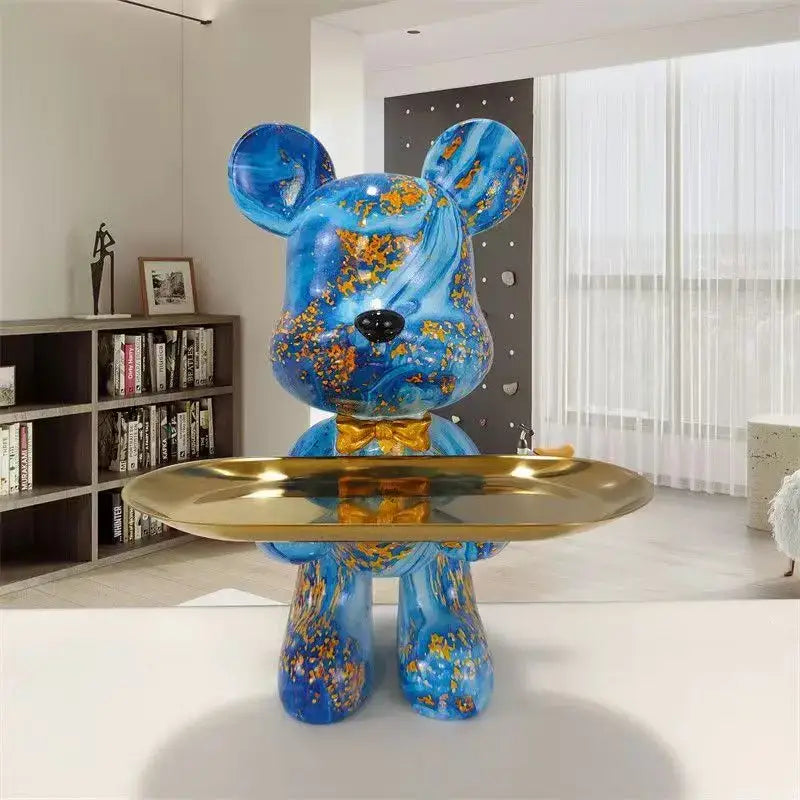Glossy blue bear figurine with gold leaf patterns and bow tie holding a brass tray decorbites graffiti bear key tray